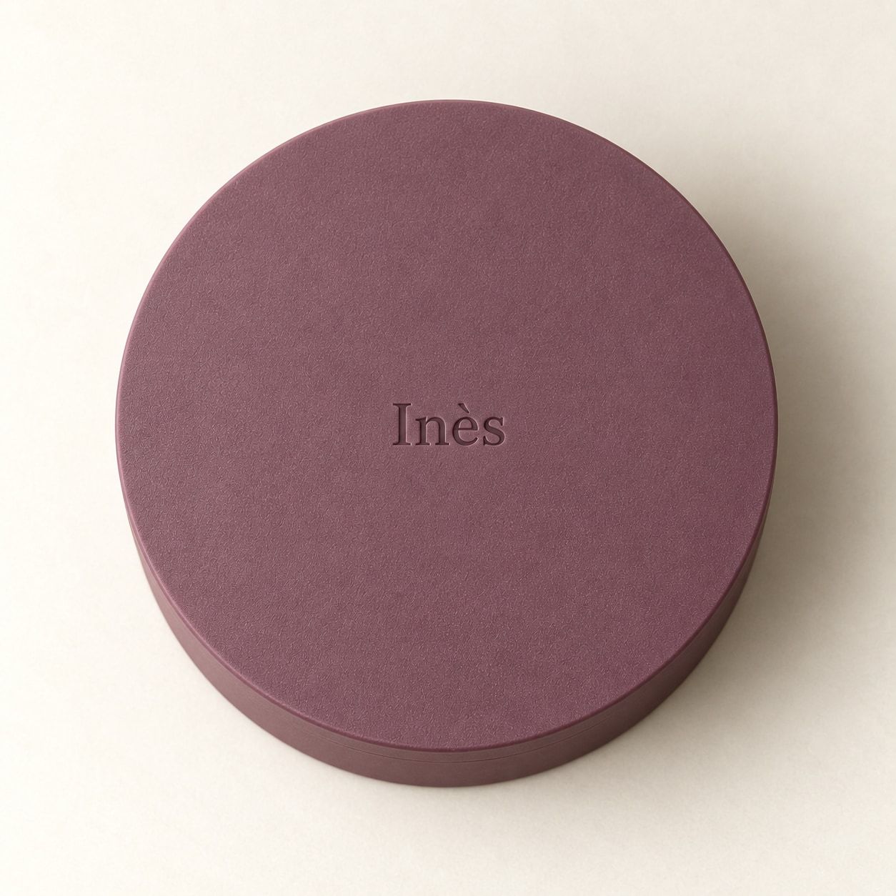 علبة دائرية برقوقية بغطاء يحمل اسم Inès