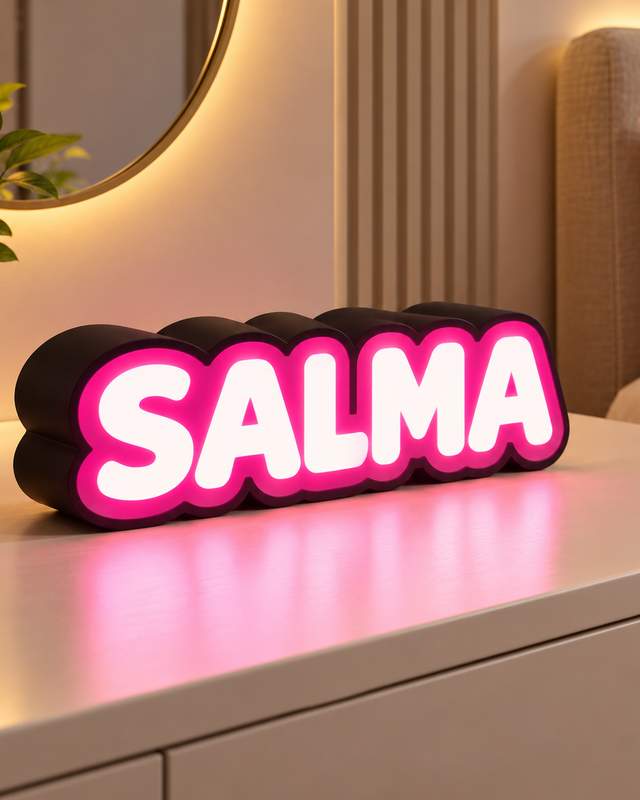 Décoration lumineuse à poser avec prénom SALMA en exemple, lettres claires, bordure rose et contour sombre.